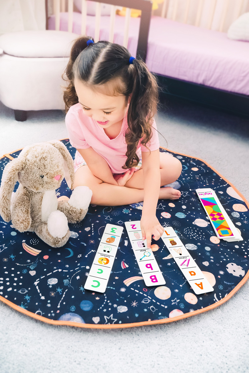 Little girl playing with Inclusive ABC Cards